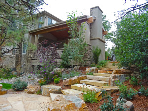 Mile High Landscaping traditional rustic slab stair accent boulder flagstone patio covered deck outdoor living custom fireplace